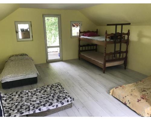 a bedroom with two bunk beds in a room at green house at silver lake in Ostrovo