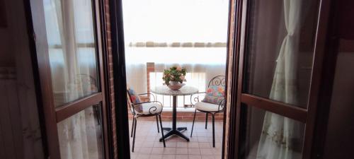 a view of a table and chairs from a window at A casa di Ilde in Silvi Marina