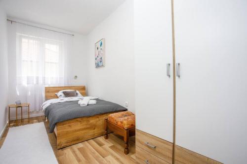 a bedroom with a bed and a glass wall at New Charming Apartment Ivana - centrally located in Sinj