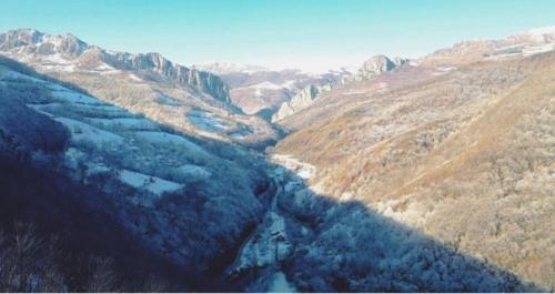 an aerial view of a valley in the mountains at Relax and Smile Rameț in Biceşti