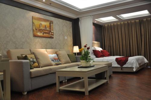 a living room with a couch and a bed at Ring Service Apartment 798 Art Zone in Beijing