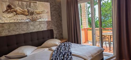 a bedroom with a bed and a view of a patio at Apartman Hana 2 in Rab