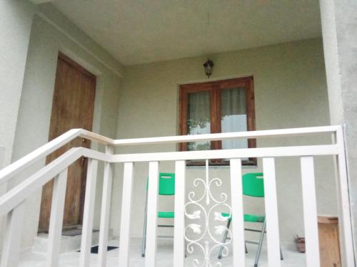 a white staircase with green and white stools at Art Racha in Ambrolauri