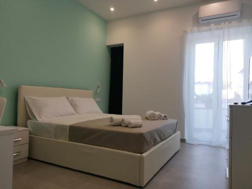 a bedroom with a bed with towels on it at Casa Verdemare in Ischia