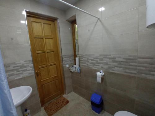 a bathroom with a shower with a toilet and a sink at Art Racha in Ambrolauri