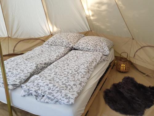 1 cama en una tienda de campaña con 2 almohadas y lámpara en Honeymoon Zelt im Ruhrpott en Oberhausen