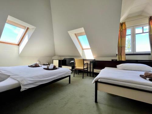A bed or beds in a room at Penzion Félix