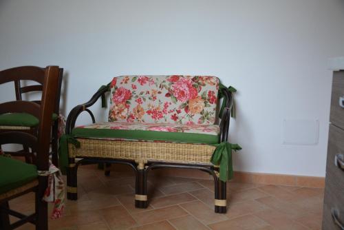 a chair with a floral pillow on it at Nonna Alda in Spoleto