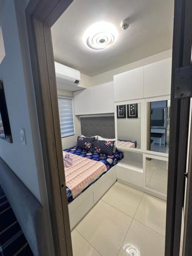 a small bedroom with a bed in a room at Sea Residences MOA Manila by JO in Manila