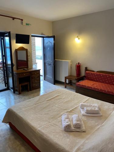 a bedroom with a bed with towels on it at Anastasia Village in Nikiana