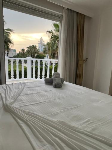 a white bed with a stuffed animal on top of it at Villabelek8 in Belek