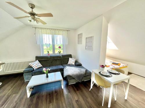 a living room with a couch and a table at Holiday Apartment Žabovřesky in Hluboká nad Vltavou