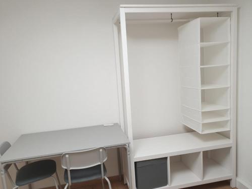 a desk and two chairs in a closet at Workers Heaven Monteur - Arbeiter Zimmer in Lörrach