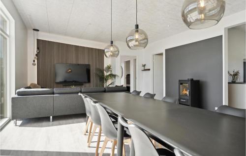 a dining room with a long table and chairs at Pet Friendly Home In Børkop With Wifi in Børkop