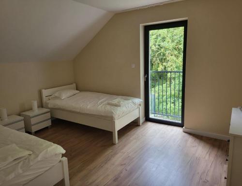 a bedroom with a bed and a large window at New House for Vip's in Słubice
