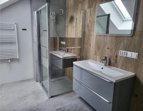 a bathroom with a shower and a sink and a mirror at New House for Vip's in Słubice