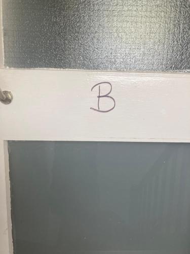 a sign with the letter b on top of a door at 3 Bed Sea View Apartment @ 10B George Street in Ryde