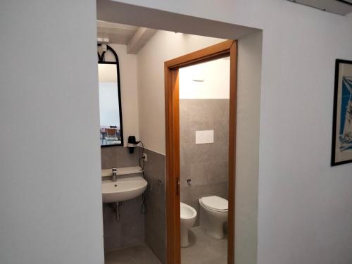 a bathroom with a sink and a toilet and a mirror at Cuntarati Nature Tourism - Simeto Etna in Bronte