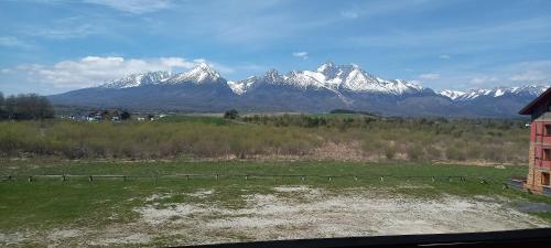 a view of a mountain range with snow covered mountains at Apartmány Paula F 302 in Veľká Lomnica