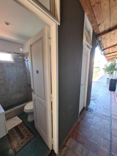 a bathroom with a shower and a toilet in it at Hotel Costa Rica in Buenos Aires