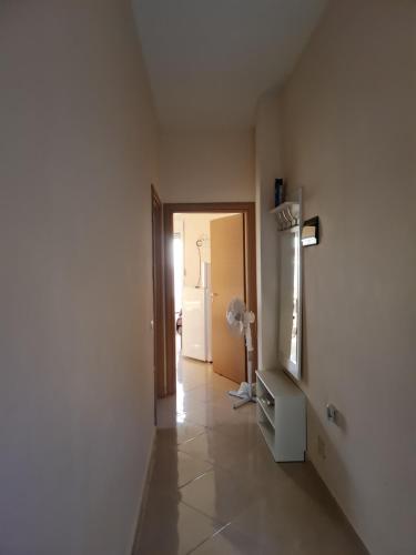 a room with a hallway with a door and a room with a fan at Ionian Breeze Apartments Borsh in Borsh
