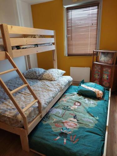 - une chambre avec deux lits superposés et un lit dans l'établissement Appartement 65 m² avec piscine., à Tours