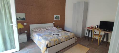 a bedroom with a bed and a desk and a television at Villa Montemma in Montesarchio