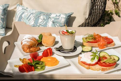 a table with two plates of food and a drink at Can Joan Capo - Adults Only in Sineu