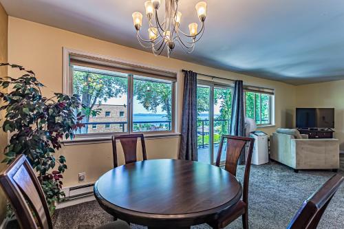 a dining room with a table and chairs and a window at Puget Sound View, Best Area, 2 Baths, 2 Bedrooms, WD, Jacuzzi Bath, New Carpet, Balcony, View, 925sf in Tacoma