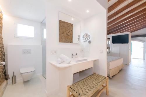 a white bathroom with a sink and a toilet at Alcotx Country Club in Es Mercadal