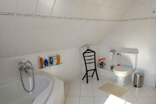 a bathroom with a bath tub and a toilet at Ferienwohnung nahe der Ostsee in Steinhagen