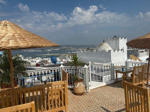a balcony with a view of the ocean and buildings at Kasba blanca in Tangier