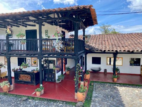 ein Haus mit einer Terrasse und einem Balkon in der Unterkunft Hotel Anacaona in San Agustín