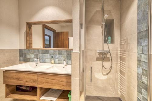 a bathroom with a sink and a shower at Oxalis in Morillon