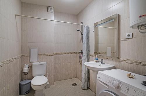 a bathroom with a toilet and a sink at Garden Palace in Varna City