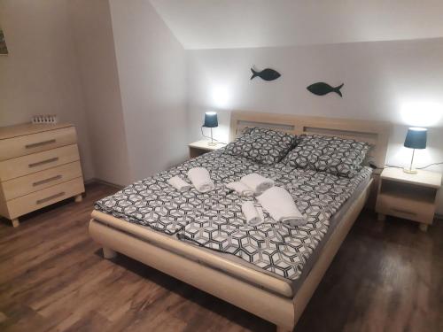 a bedroom with a bed with two pillows on it at Apartament Świerkowa 11 in Augustów
