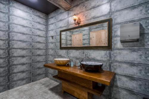 a bathroom with two sinks and a mirror at SVANETI in Lentekhi