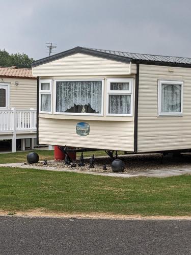 a tiny house sitting on the side of a house at E16 Millfields 6 berth caravan MAX 4 ADULTS Bob family's only and lead person must be over 30 in Ingoldmells