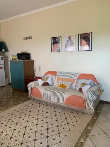 a bed sitting in a living room next to a wall at Casa Vacanze La Brii in Iglesias