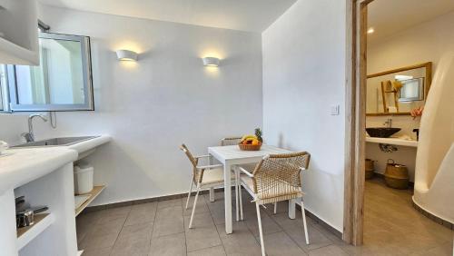 a kitchen and dining room with a table and chairs at Polychronis Private Suite in Pollonia