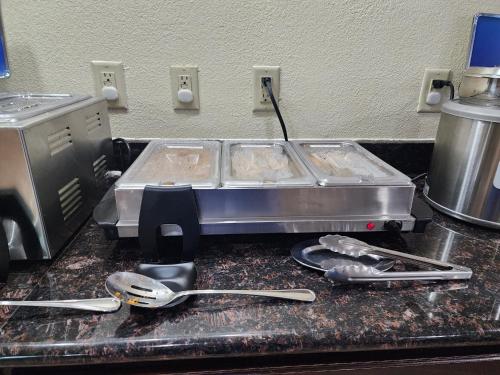 a kitchen counter with two trays of food on it at Best Western Richland Inn Mansfield in Mansfield