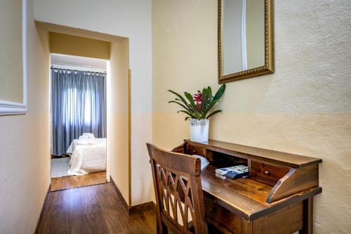 a wooden desk in a room with a mirror at Hotel Minerva in Pisa