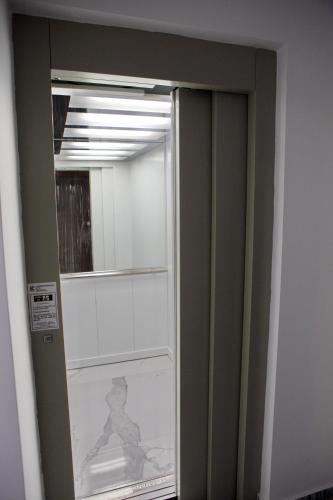 a glass door with a mirror in a room at 90° - Ninety Degrees in Nafplio