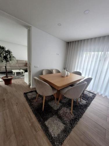 a dining room with a wooden table and chairs at Cidade_Berço House in Guimarães