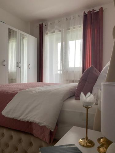 a bedroom with a bed and a window at Lilien apartman in Veternik