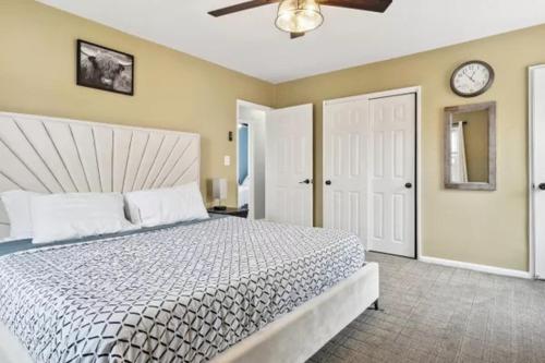 a bedroom with a bed and a clock on the wall at Rockaway 3 bedroom suite by the Sea. in Wave Crest
