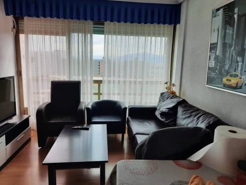 a living room with a couch and chairs and a television at Apartamento / piso , centrico. in Santander