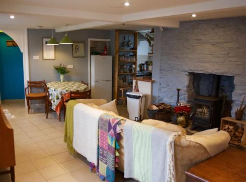 a living room with a couch and a fireplace at Entire characterful cottage in Calstock, Cornwall in Calstock