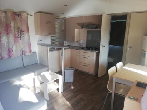 a small apartment with a kitchen and a table at mobil home Gassin in Gassin
