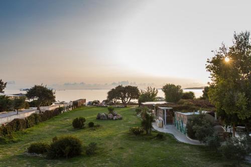 a view of a yard with a view of the water at Athina Studios and Suites Plaka in Plaka
